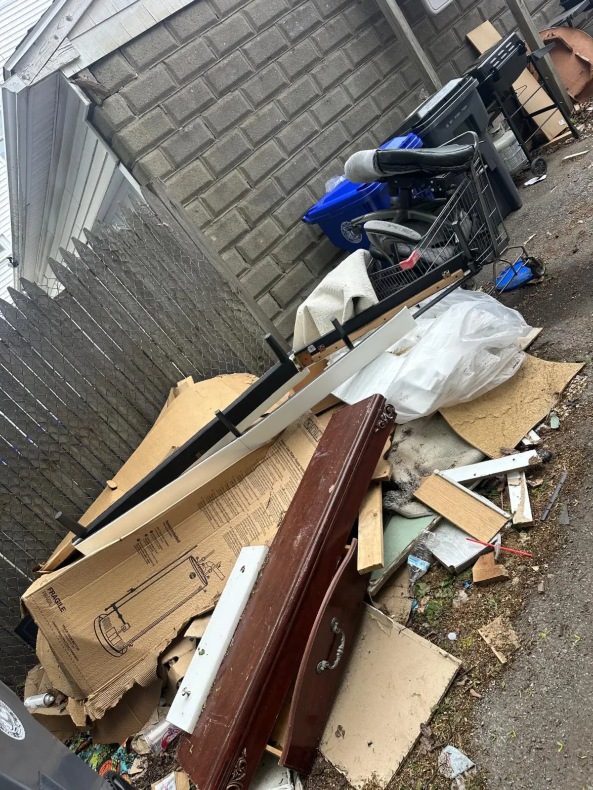 Boxes, furniture and trash piled in a side alley before removal in Rhode Island