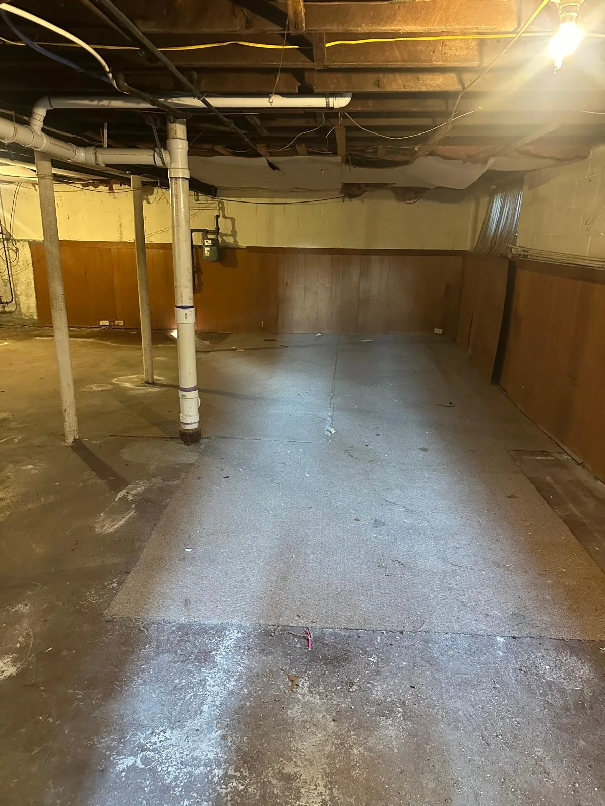 Junk removal before and after Rhode Island: basement floor swept after a full cleanout