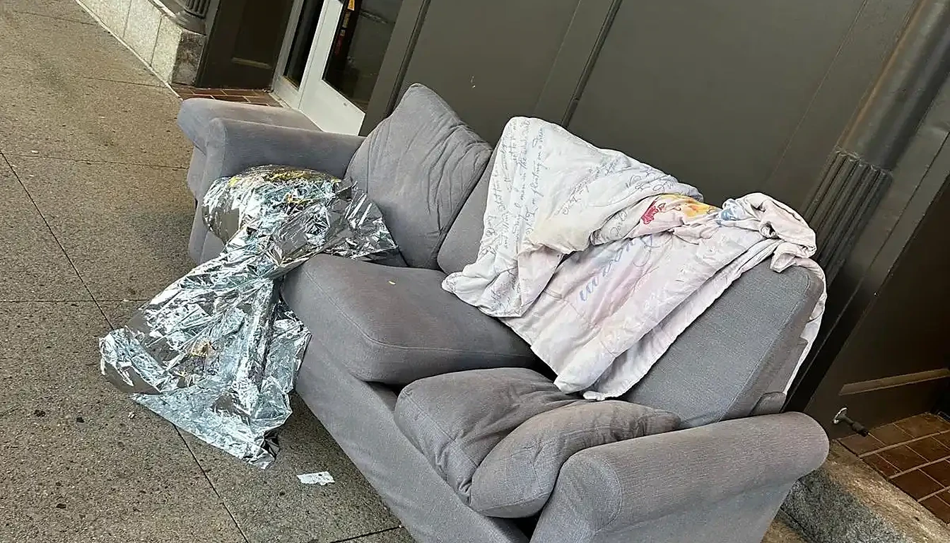 Old couch dumped outside a storefront before removal in Rhode Island