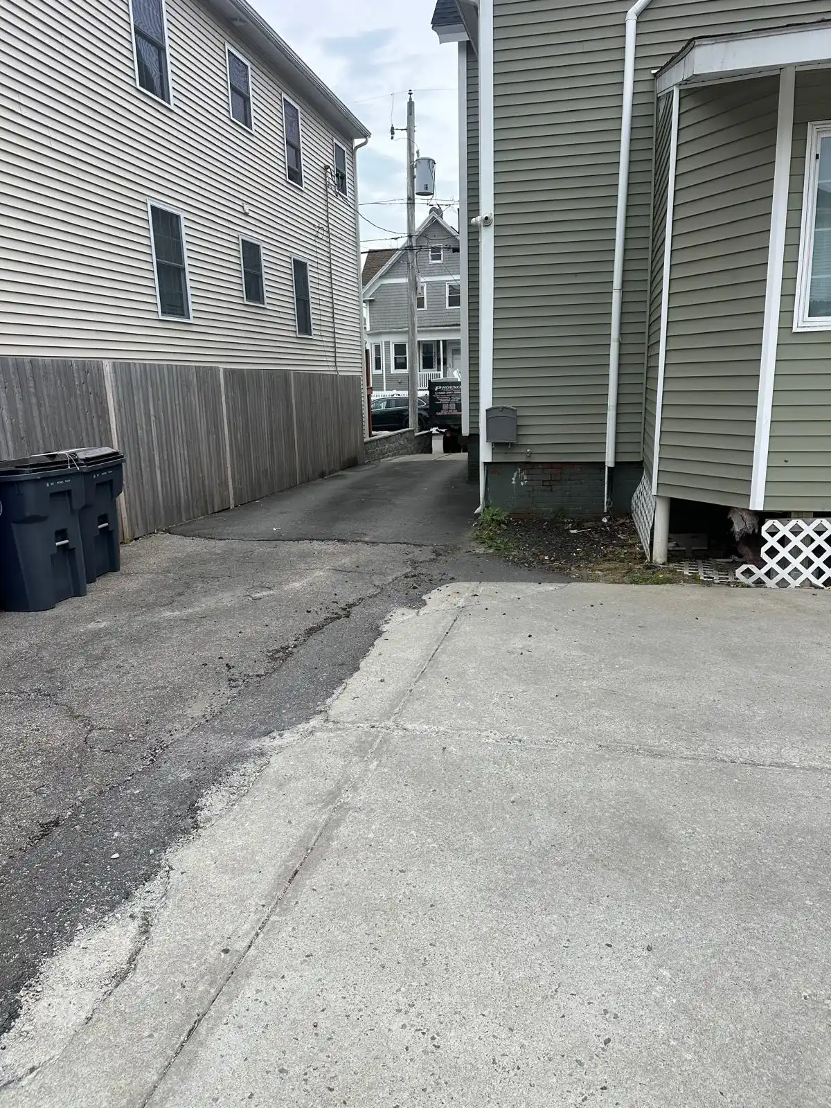 Driveway between two houses cleared after junk removal