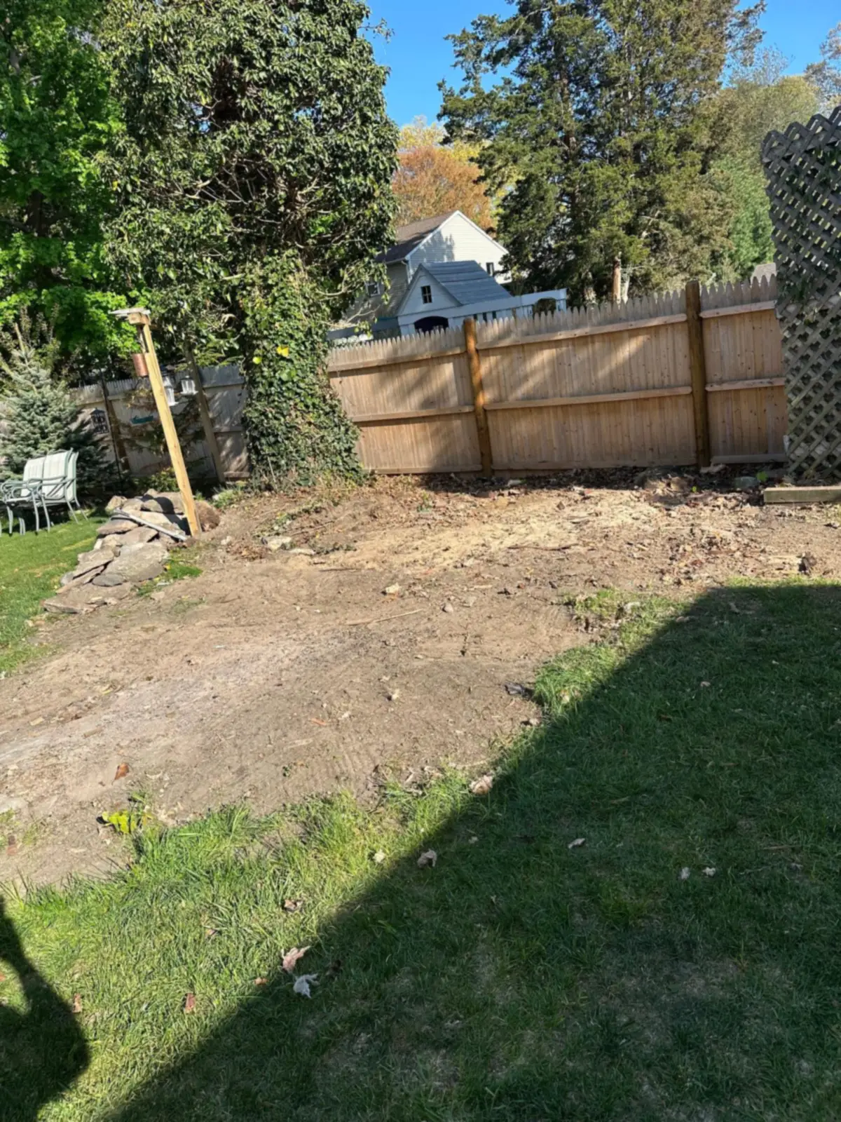 Bare ground where the shed stood after demolition and removal