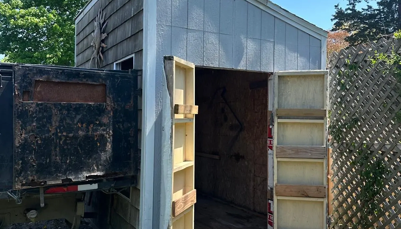 Grey shed beside the trailer before demolition and removal