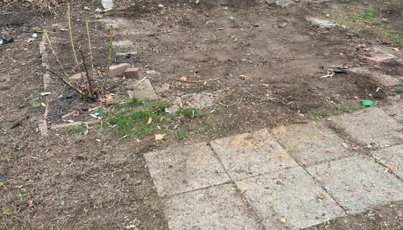 Bare ground and paving slabs left after shed removal in Rhode Island